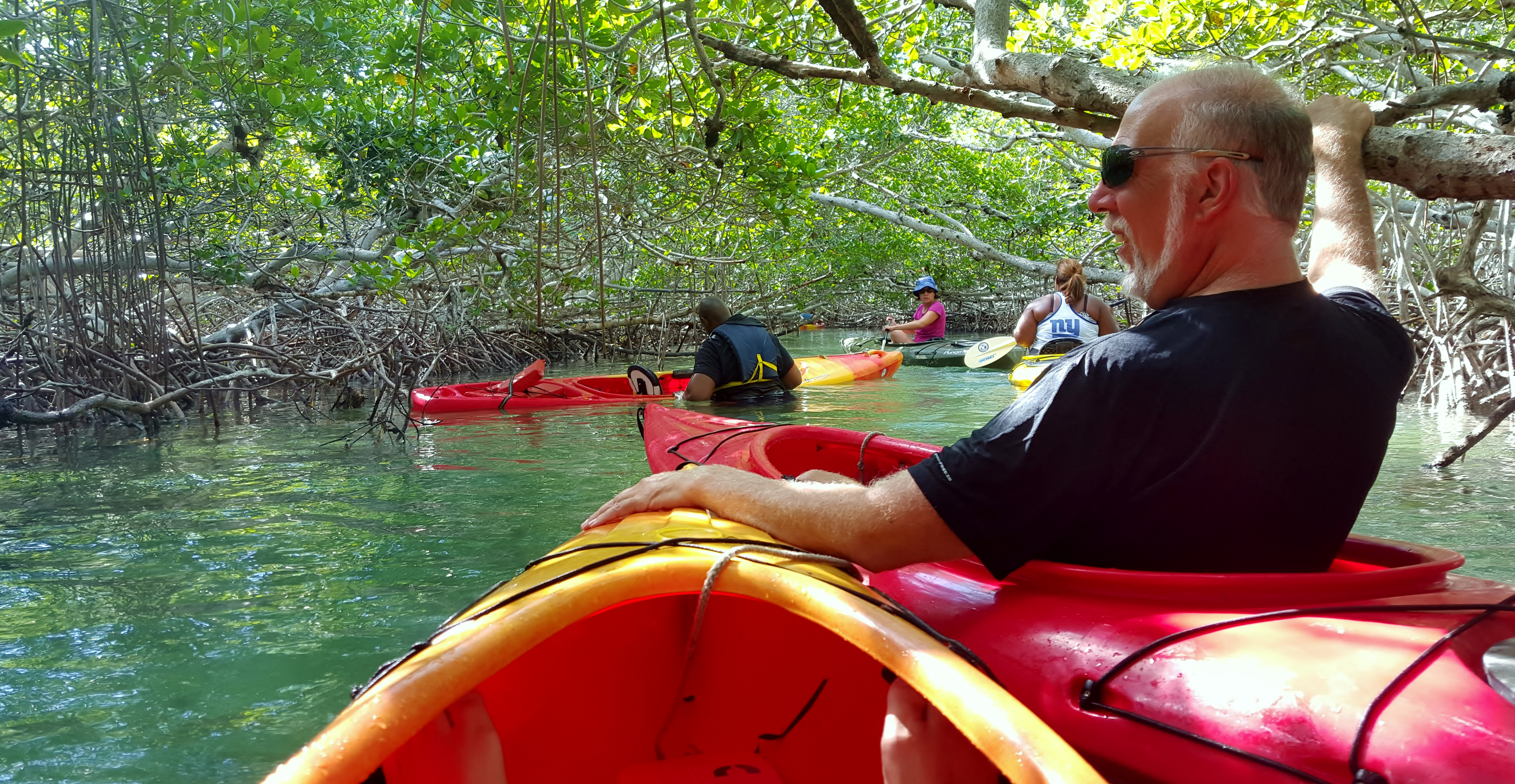 Mike watches as Bubba attempts to get back into his kayak. Thelma is still roped to his kayak. Our tour guide struggles to help.