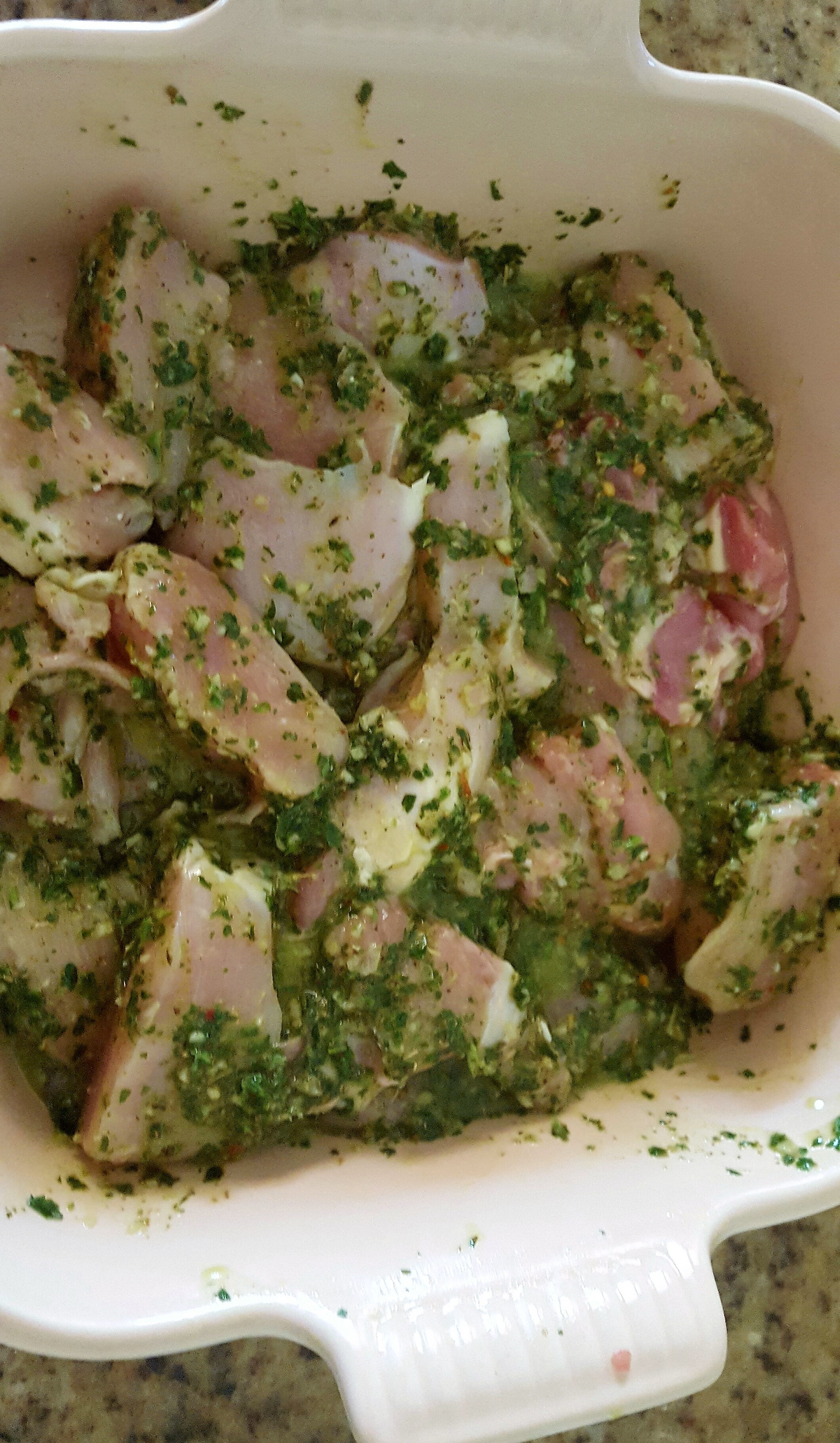 chimichurri marinating in raw chicken